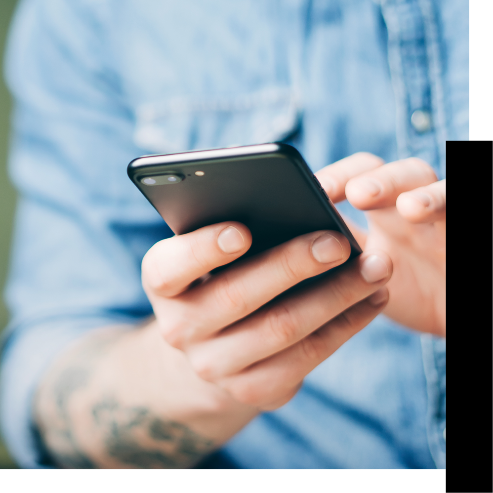 Close up of a man's hands typing at a phone screen