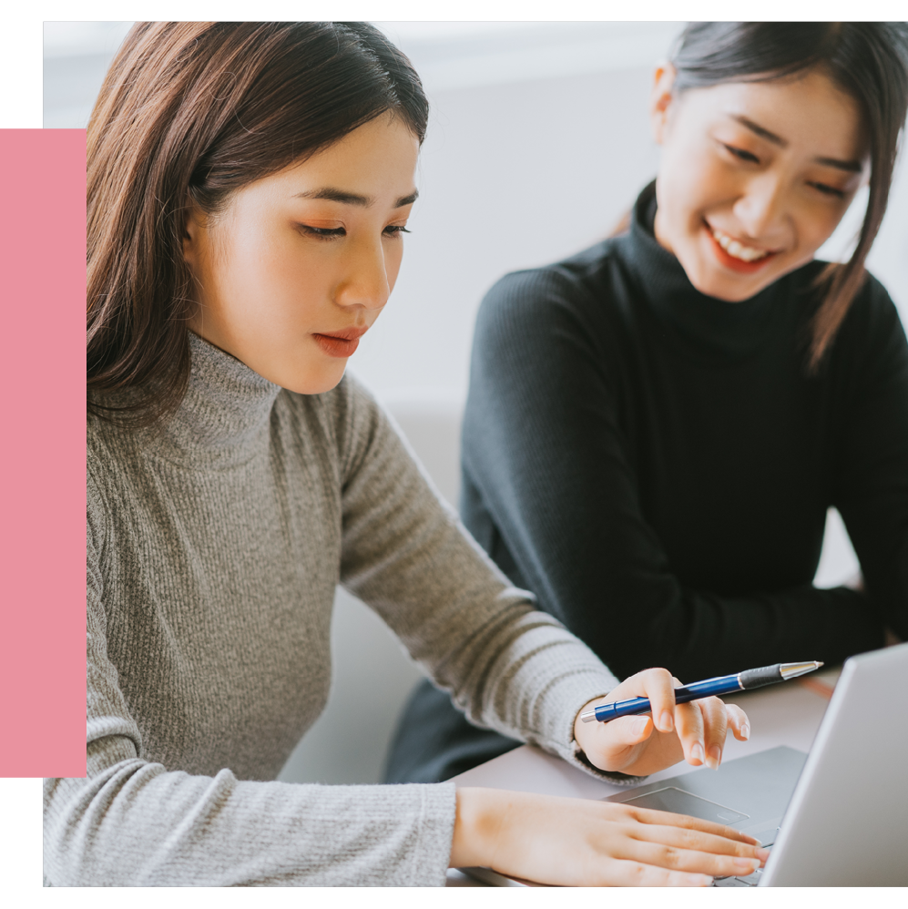 Two female asian colleagues at a laptop